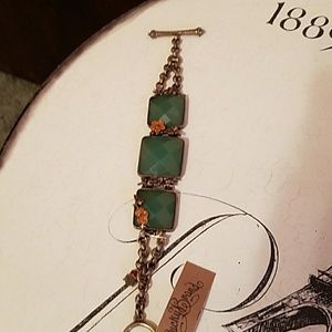 Brass bracelet with green stones.